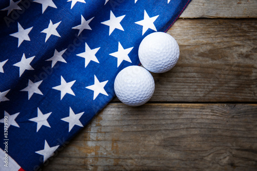Golf ball with flag of USA on wood table