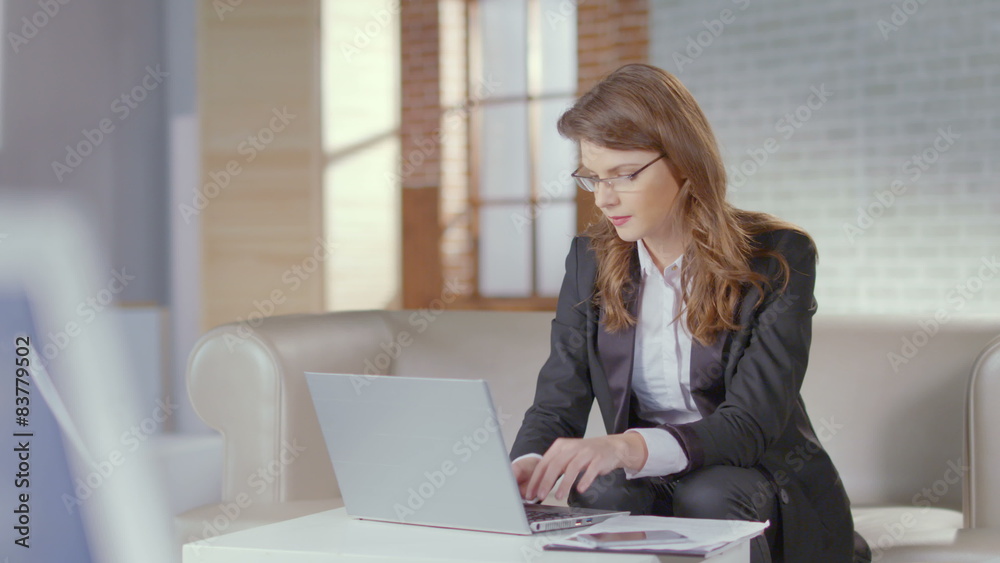 Attractive woman business suit working in office, using laptop Attractive woman business suit working in office, using laptop