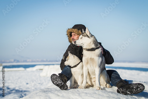 The Old Man and sled dogs on an ice floe.