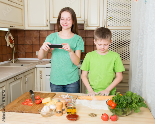 Children cooking homemade pizza at home kitchen. Food photoe. photo