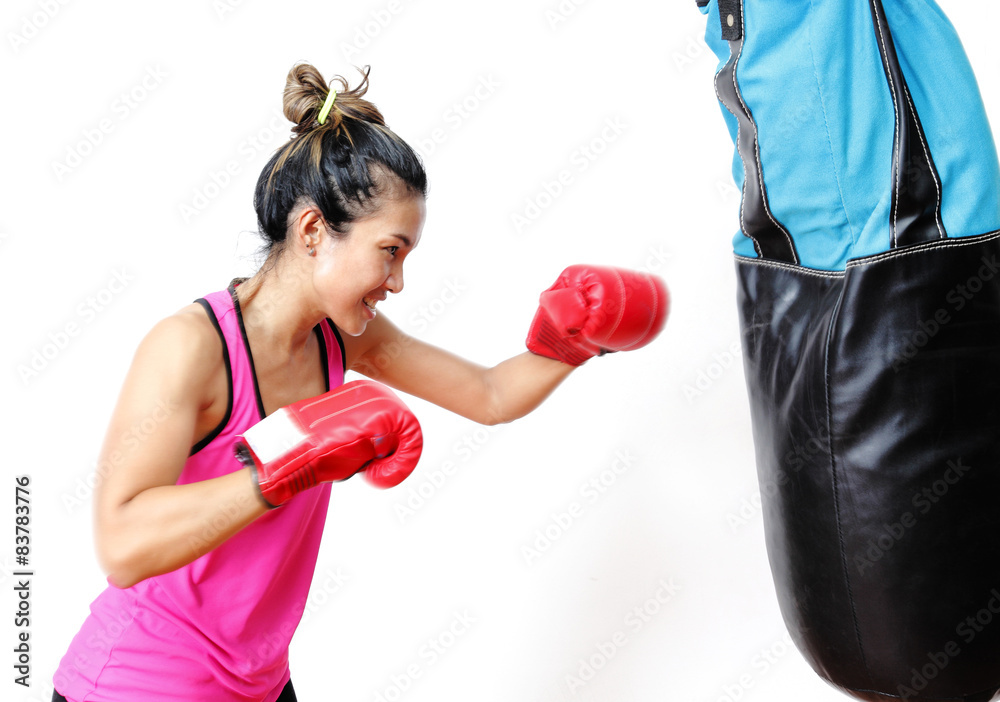 attractive young woman making a punch on the blue sandbag attractive young woman making a punch on the blue sandbag