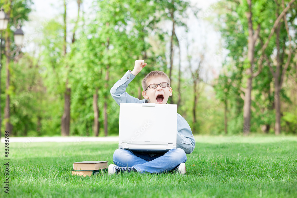 boy with a books and laptop computer boy with a books and laptop computer