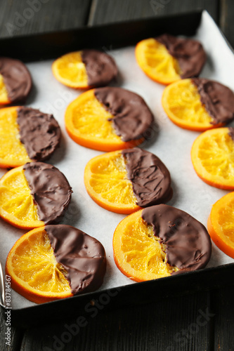 Delicious slices of orange coated chocolate on pan