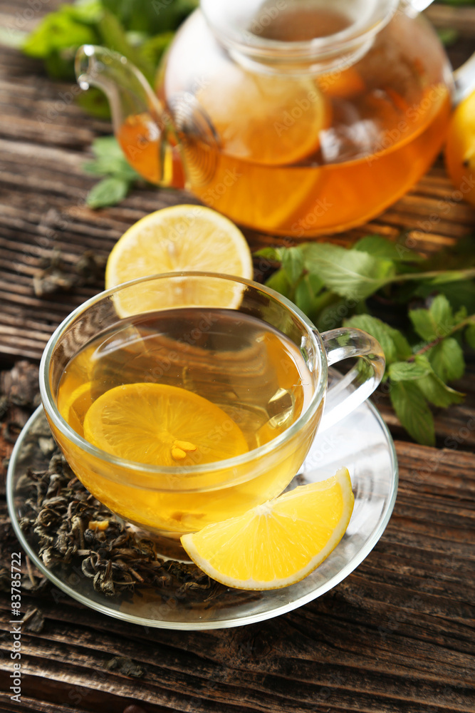 Cup with green tea and teapot Cup with green tea and teapot