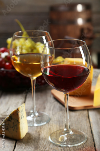 Glass of red and white wine  cheeses and grapes 