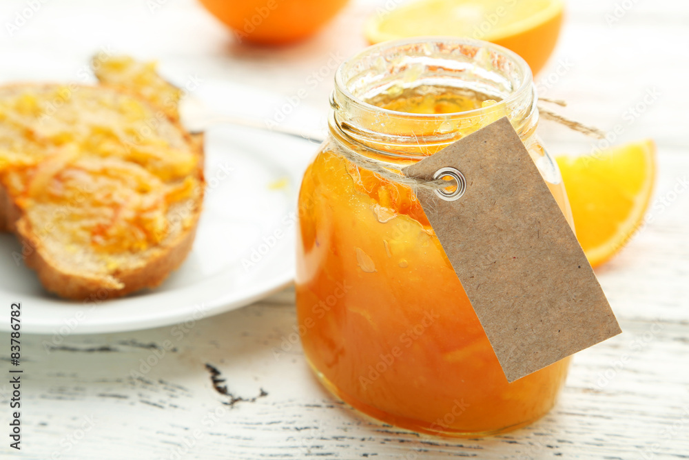 Orange juice in bottle and orange in basket Orange juice in bottle and orange in basket