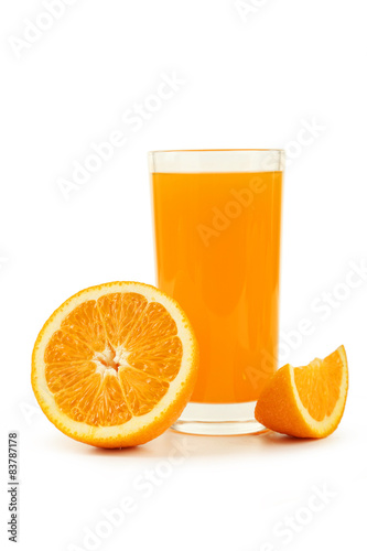 Glass of fresh orange juice on wooden background
