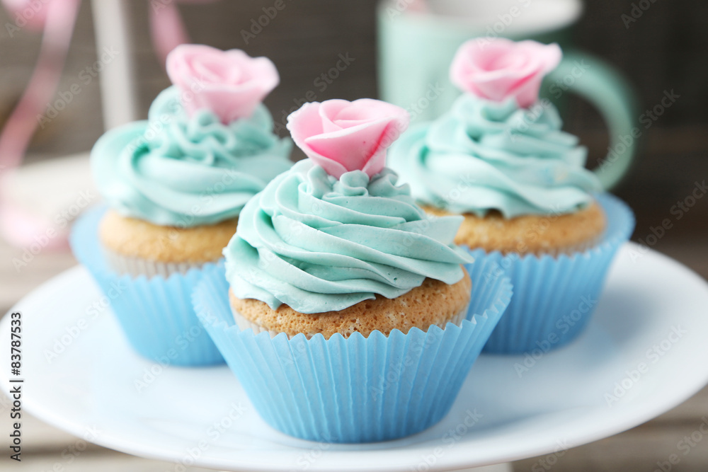 Tasty cupcake on grey wooden background