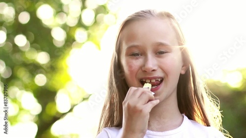 Adorable little girl licks ledinets lolly photo