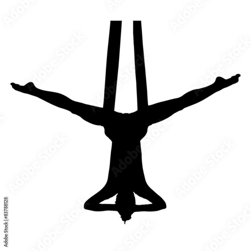 Aerial performer hanging on silk in symmetric pose