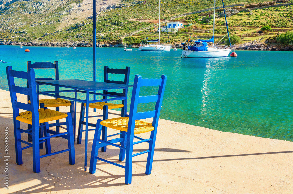 Wooden blue chairs in Greek restaurant, Greece