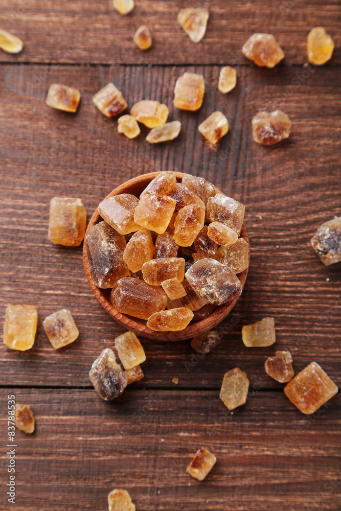 Brown sugar in spoon and bowl on wooden background Brown sugar in spoon and bowl on wooden background