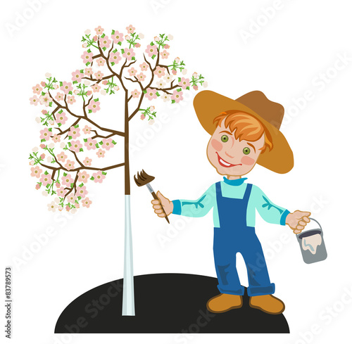 Gardener boy with a paint brush whitening apple tree.