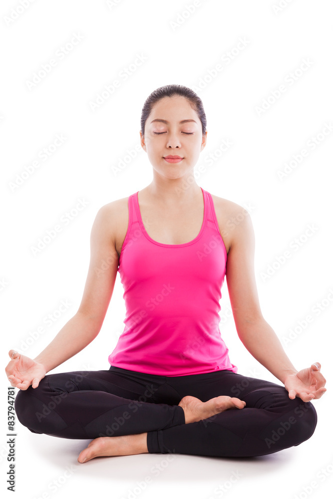 Beautiful young woman practicing yoga, sitting in a lotus pose