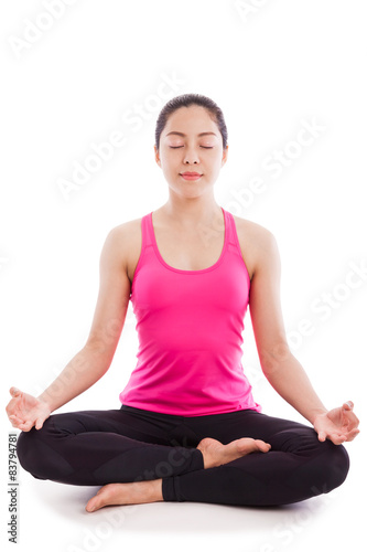 Beautiful young woman practicing yoga, sitting in a lotus pose