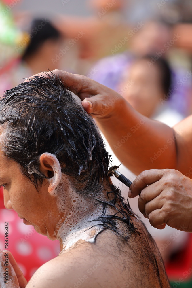 Naklejka premium Male who will be monk shaving hair for be Ordained