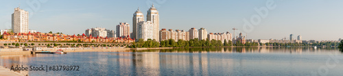 The first sun rays caresse the buildings close to the Dnieper river in Kiev  panoramic view