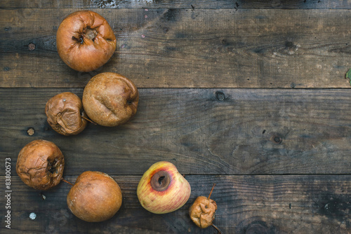 Rotten apples on wood