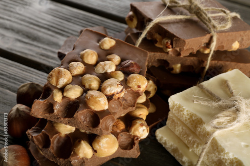 Set of chocolate with hazelnut on wooden table, closeup