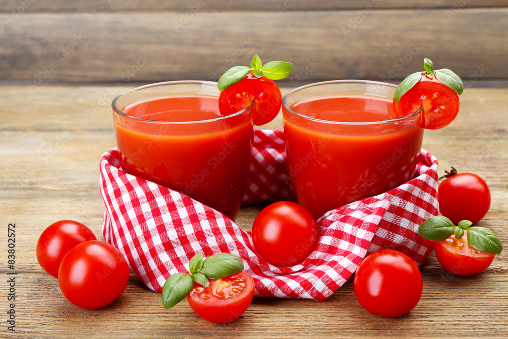 Glasses of tomato juice with vegetables on wooden background Glasses of tomato juice with vegetables on wooden background