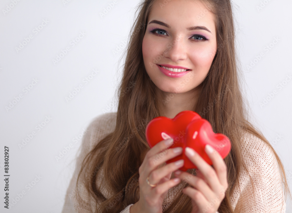Portrait of beautiful happy woman holding a symbol heart. Portrait of beautiful happy woman holding a symbol heart.