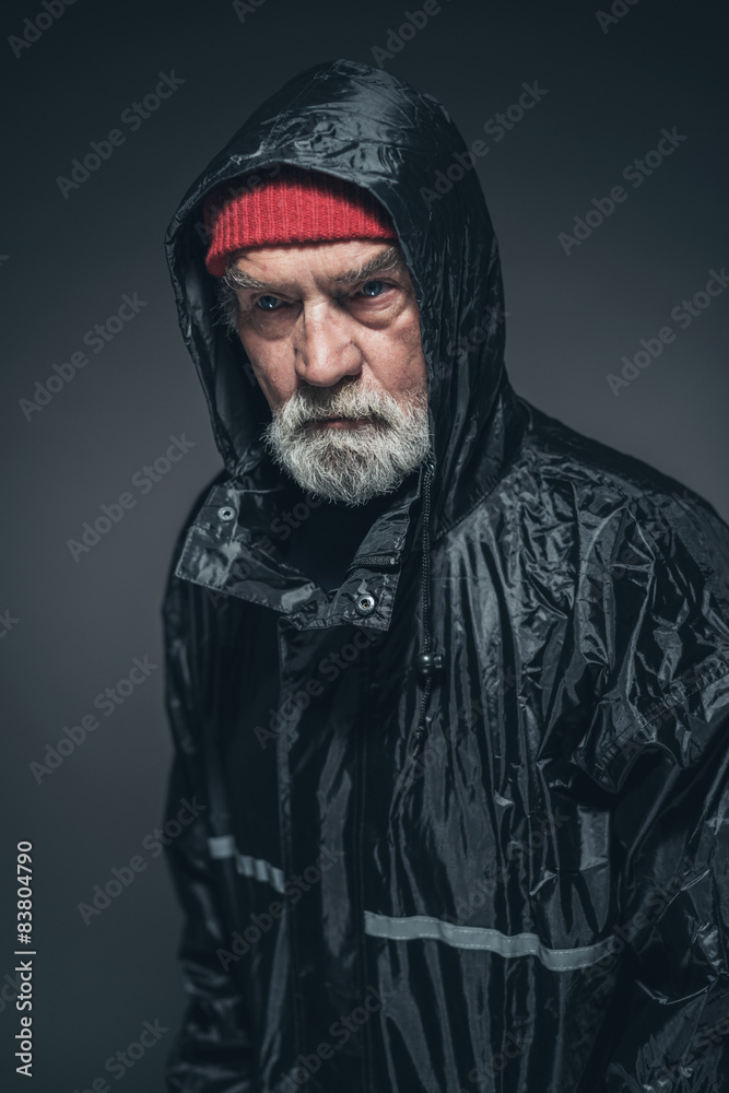 Elderly Man Wearing Bonnet and Rain Slicker