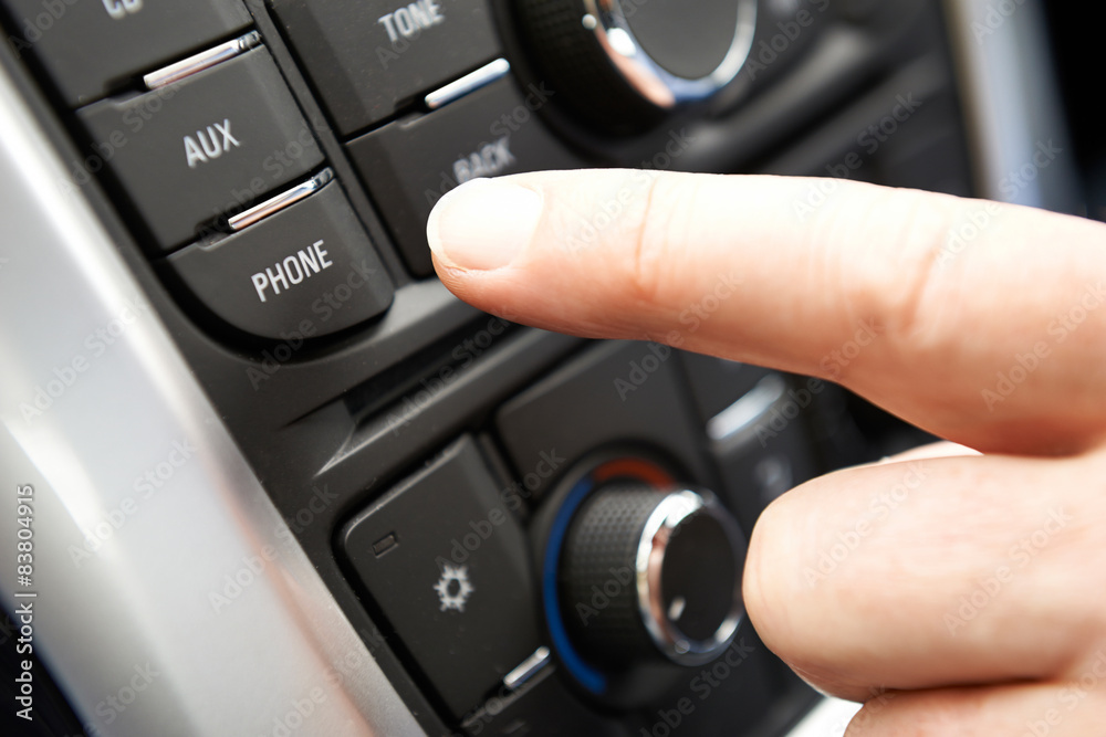 Close Up Of Hand Pressing Car Bluetooth Control On Dashboard Close Up Of Hand Pressing Car Bluetooth Control On Dashboard