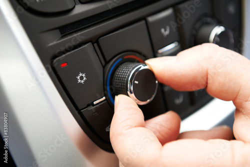 Close Up Of Hand Adjusting Car Air Conditioning Control On Dashb © highwaystarz