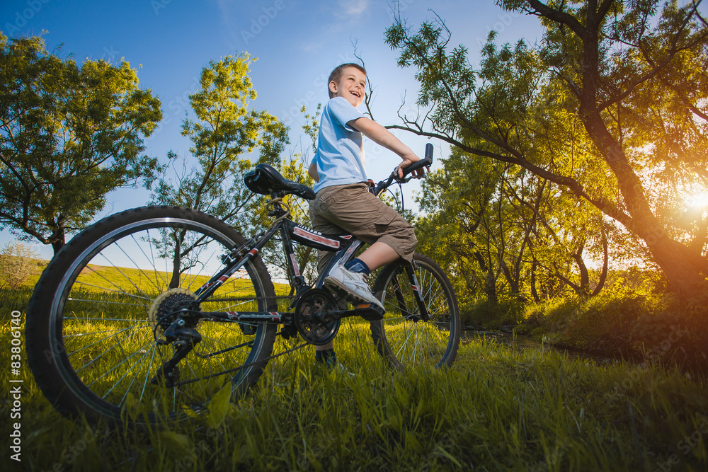Obraz premium happy funny kid on bicycle. Active Leisure