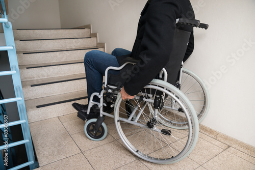 Man On Wheelchair In Front Of Staircase