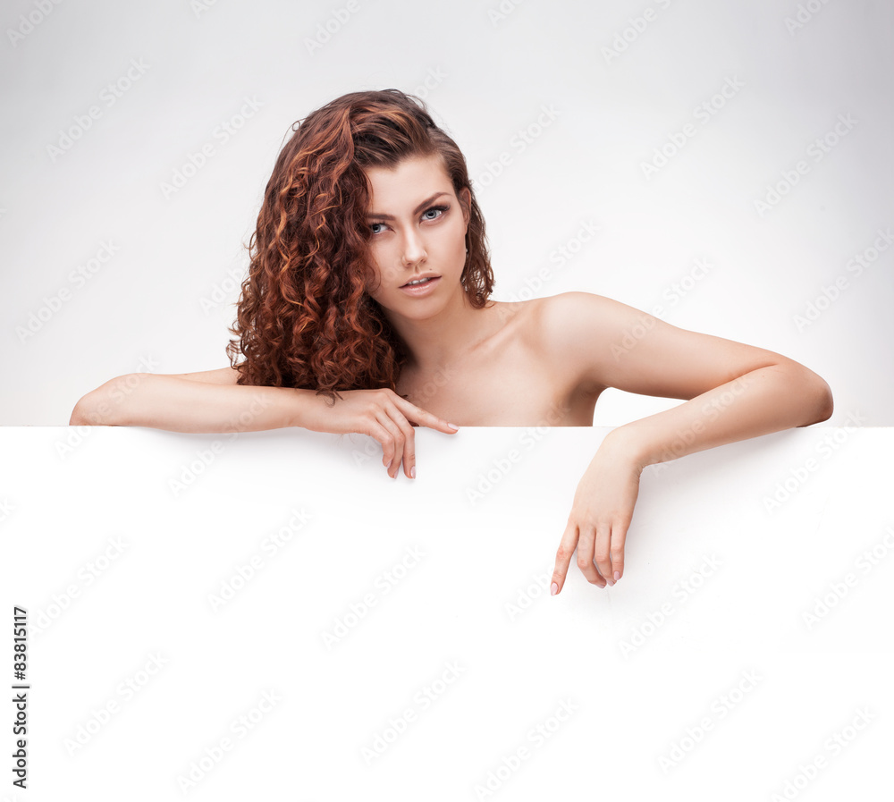 woman with brown curly hair holding signboard woman with brown curly hair holding signboard