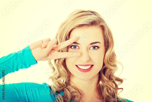 Young woman showing victory sign