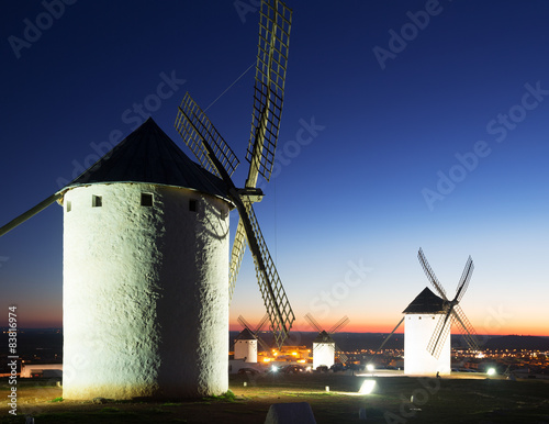 Group of windmills at field in evening