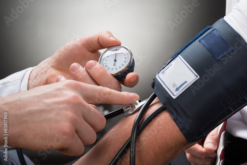 Doctor Checking Blood Pressure Of A Patient photo