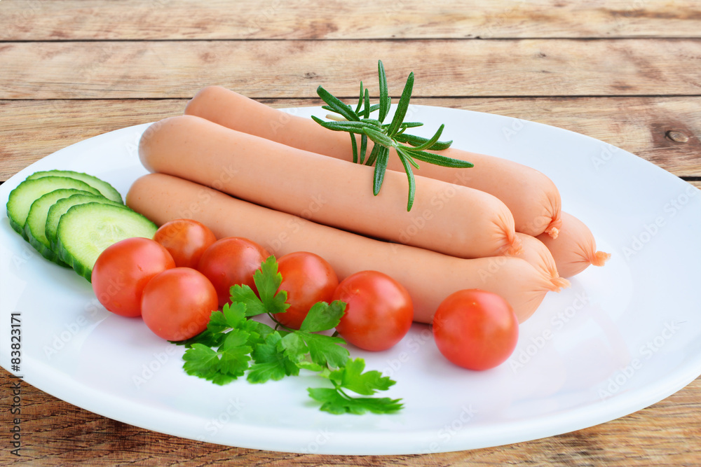 Sausages and vegetables over wooden table