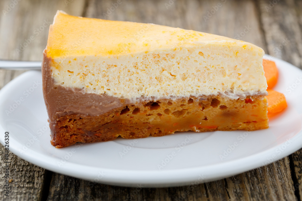 Sweet slice of carrot cake on white plate.