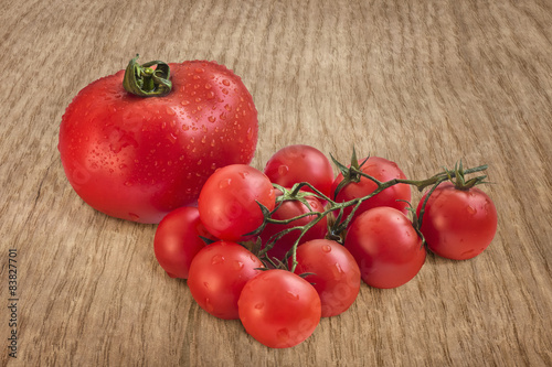 Bunch Of Fresh Juicy Tomatoes On Rustic Wooden Table