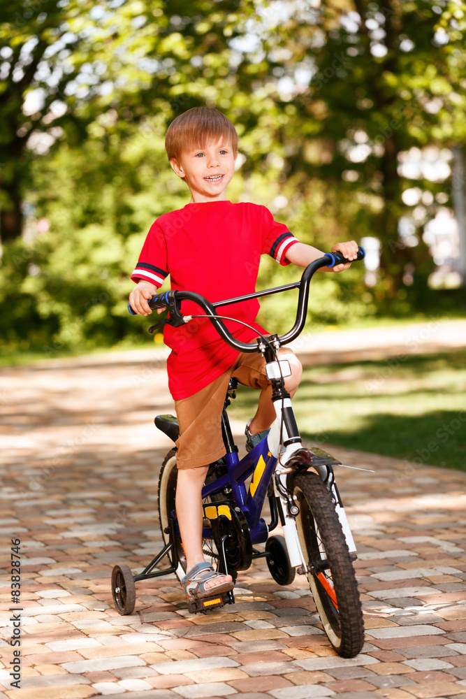 Smiling little boy riding bike Smiling little boy riding bike