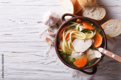 rustic chicken soup with noodles. Horizontal top view
