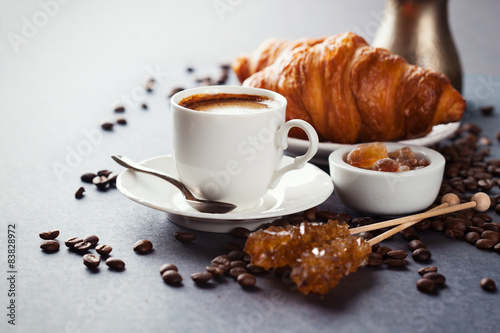 Fresh croissants and cup of coffee on a table