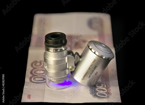 Fotografija Checking banknotes pocket currency detector