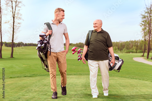Two golf players walking through course