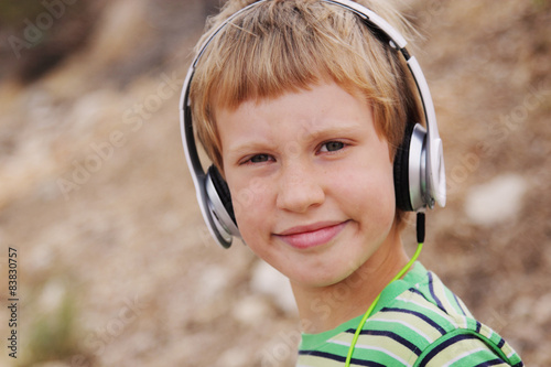 Obraz na plátne Portrait of cute autistic boy with headphones