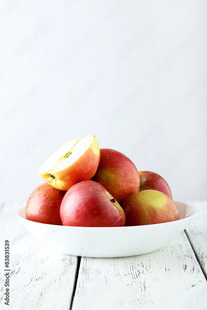 Apples in bowl on white wooden background Apples in bowl on white wooden background