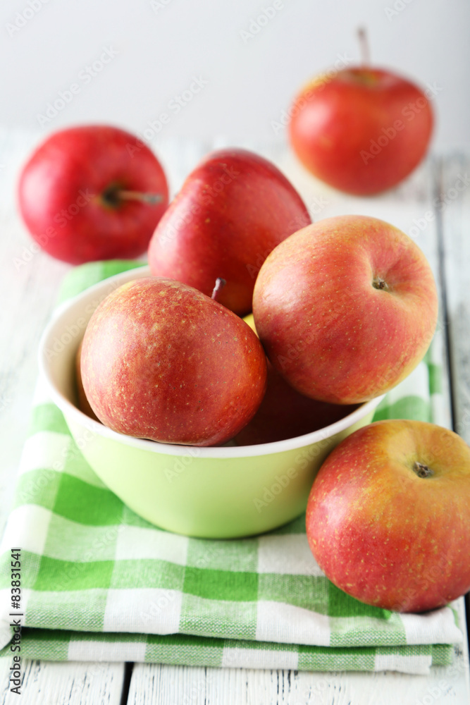 Apples in bowl on white wooden background Apples in bowl on white wooden background
