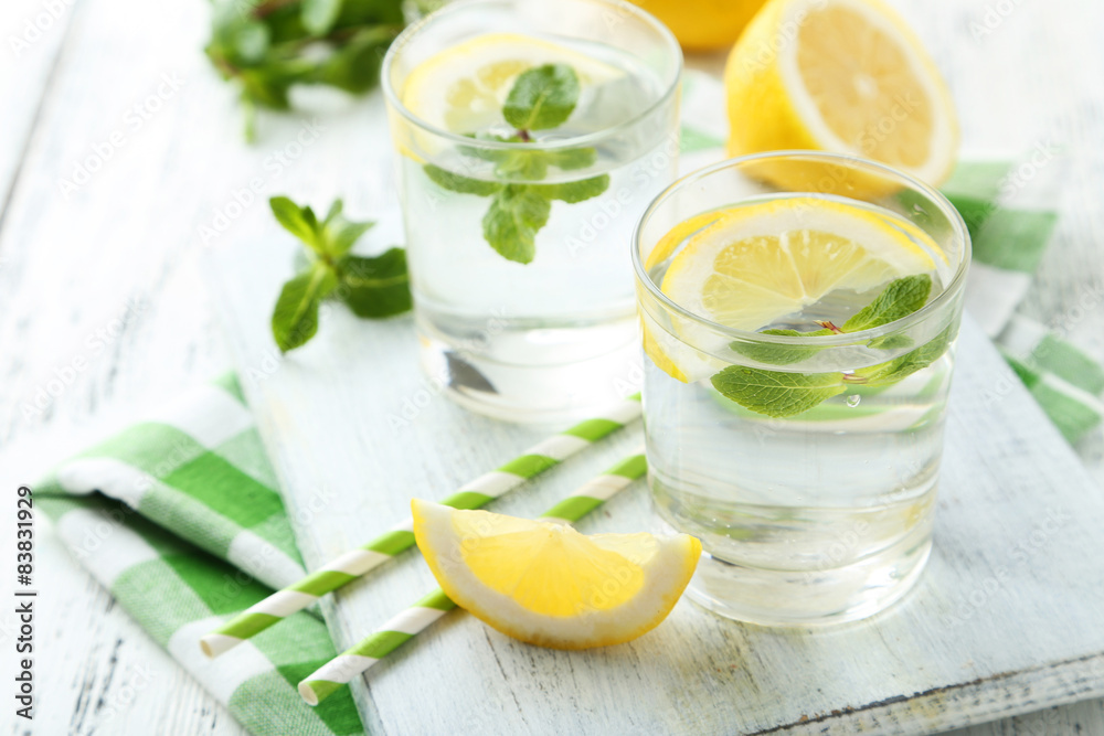 Fresh lemonade with lemon on white wooden background Fresh lemonade with lemon on white wooden background