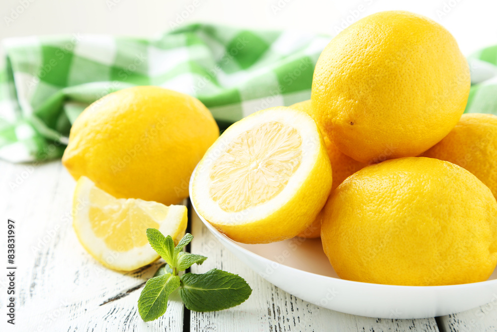 Lemons in bowl on white wooden background Lemons in bowl on white wooden background