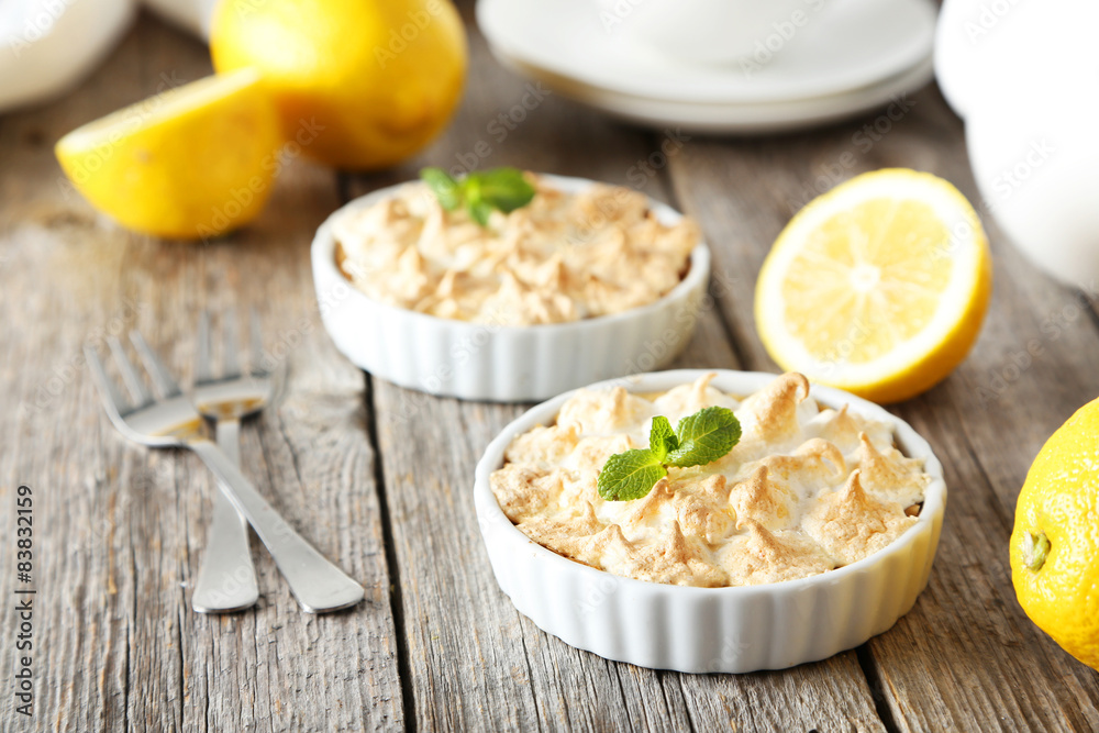 Lemon meringue pie in bowl on grey wooden background Lemon meringue pie in bowl on grey wooden background