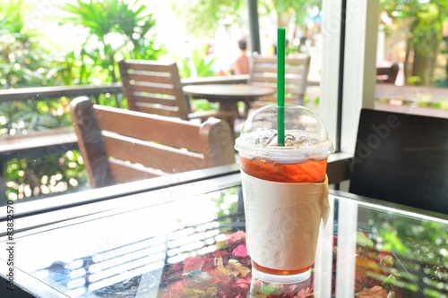 Close up of iced Lemon Tea place on the table. Along the window. photo