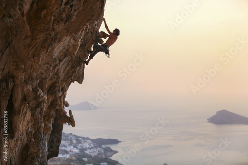 Male rock climber at sunset, Kalymnos Island, Greece